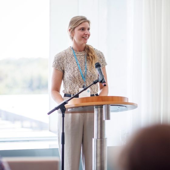 Leonie speaking at a podium